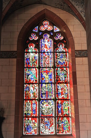 Speyer Cathedral, A detailed stained glass window in red and blue with biblical motifs floods the church with colour, Speyer Cathedral, Unesco World Heritage Site, foundation stone laid around 1030, Speyer, Rhineland-Palatinate, Germany, Europe