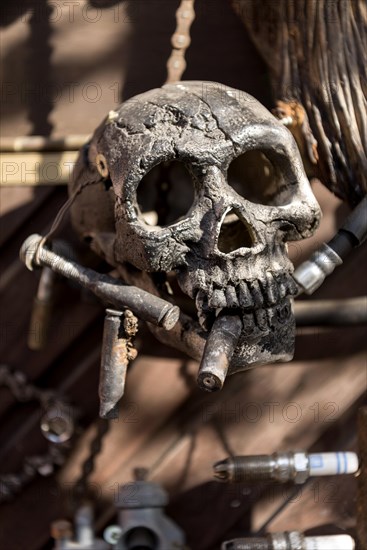 Old entrance door whimsically decorated, skull, engine parts, cartridge cases, tools, old town, Ortenberg, Vogelsberg, Wetterau, Hesse, Germany, Europe