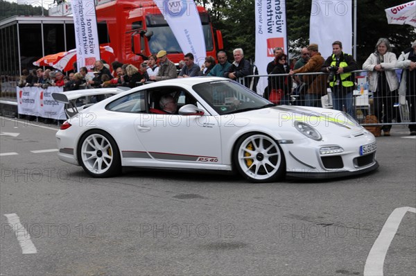 A white Porsche 911 sports car drives past spectators at a racing event, SOLITUDE REVIVAL 2011, Stuttgart, Baden-Wuerttemberg, Germany, Europe