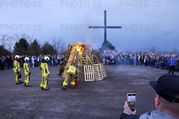 The fire brigade lights the Easter bonfire on the Haniel spoil tip in front of the summit cross, Bottrop, Ruhr area, North Rhine-Westphalia, Germany, Europe