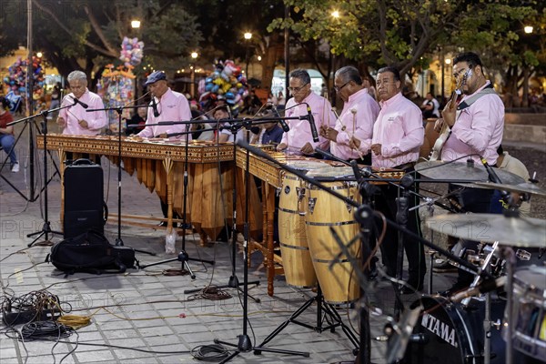 Oaxaca, Mexico, The Marimba del Estado band entertains a crowd in the zocalo. Marimba band music is traditional in southern Mexico, Central America