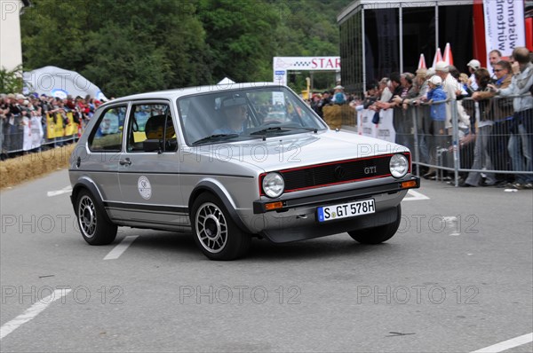 A black and red Volkswagen GTI classic car at a rally, surrounded by spectators, SOLITUDE REVIVAL 2011, Stuttgart, Baden-Wuerttemberg, Germany, Europe