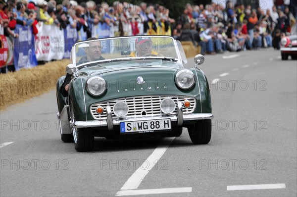 A green classic roadster drives on a road at a classic car race, SOLITUDE REVIVAL 2011, Stuttgart, Baden-Wuerttemberg, Germany, Europe