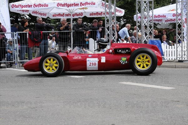 A red vintage racing car with sunshine and a driver in a yellow helmet, SOLITUDE REVIVAL 2011, Stuttgart, Baden-Wuerttemberg, Germany, Europe