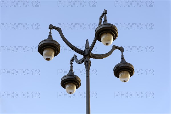 Historic-looking quadruple street lamp against a clear sky, Marseille, Departement Bouches-du-Rhone, Provence-Alpes-Cote d'Azur region, France, Europe