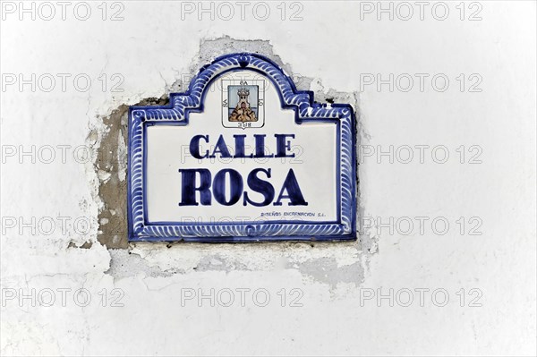 Solabrena, A white and blue ceramic sign on a wall shows 'Calle Rosa' as the street name, Andalusia, Spain, Europe