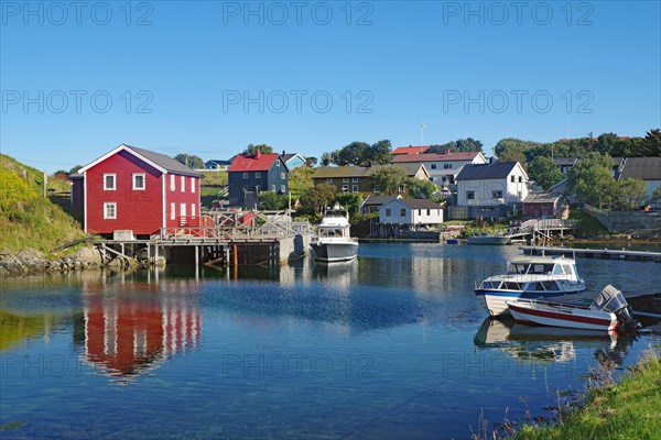 Small houses and boats in a sheltered bay, Lovunden, Helgeland coast, Traena, Norway, Europe