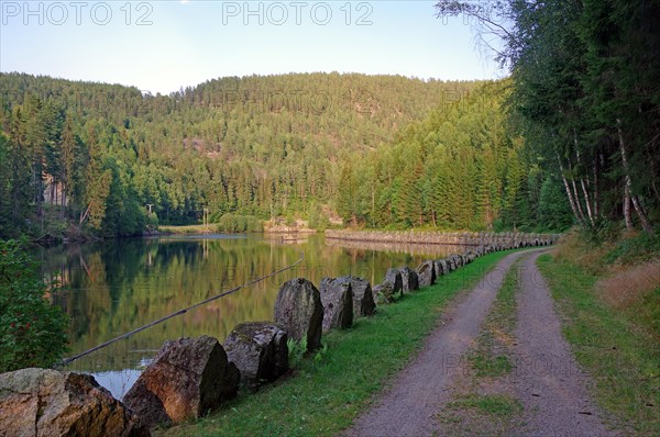 Historic towpath with stone markings along a calm waterway, Telemark Canal
