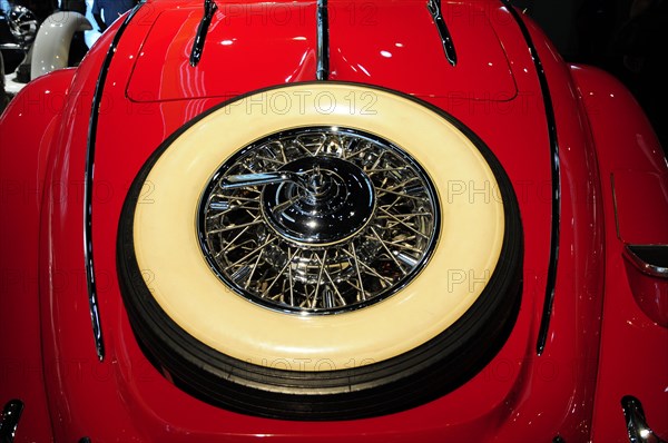 Detailed close-up of the wheel of a red vintage car, Mercedes-Benz Museum, Stuttgart, Baden-Wuerttemberg, Germany, Europe