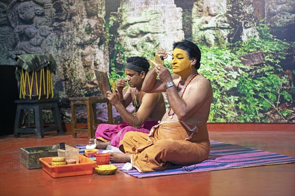 Kathakali performers or mime artists, 38 and 60 years old, make up their faces, Kochi Kathakali Centre, Kochi, Kerala, India, Asia