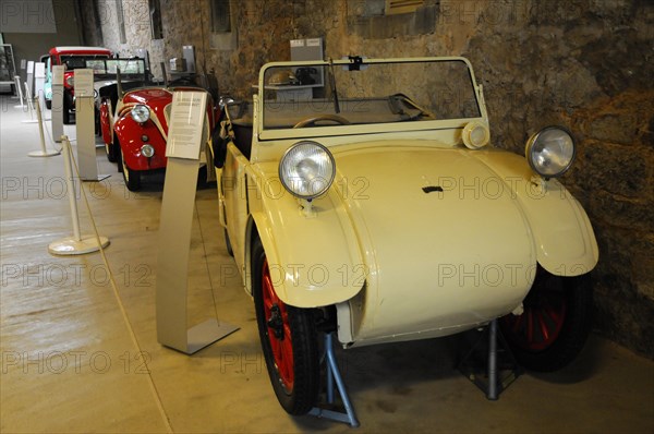 Deutsches Automuseum Langenburg, A small white vintage car in a museum, next to an information stand, Deutsches Automuseum Langenburg, Langenburg, Baden-Wuerttemberg, Germany, Europe