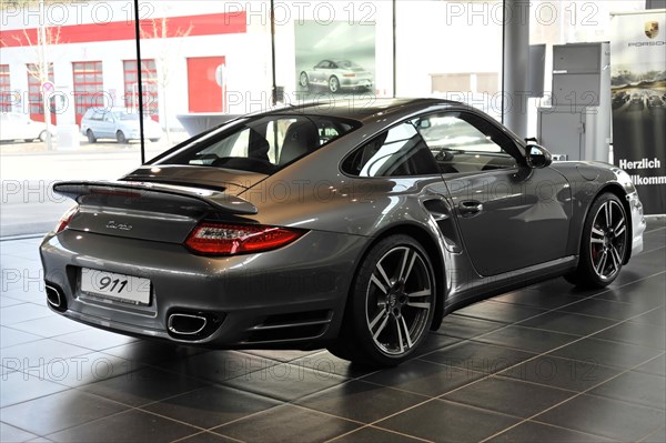 Side view of a grey Porsche 911 Coupe in a car dealership, Schwaebisch Gmuend, Baden-Wuerttemberg, Germany, Europe