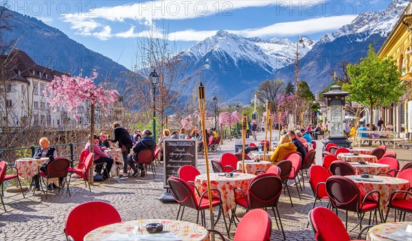 Winter promenade along the Passer with street cafe in the background the Texel Group with the peak 3006m in spring, Merano, Pass Valley, Adige Valley, Burggrafenamt, Alps, South Tyrol, Trentino-South Tyrol, Italy, Europe