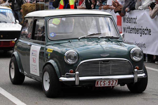 A green classic Mini with a racing number drives past spectators at a car race, SOLITUDE REVIVAL 2011, Stuttgart, Baden-Wuerttemberg, Germany, Europe