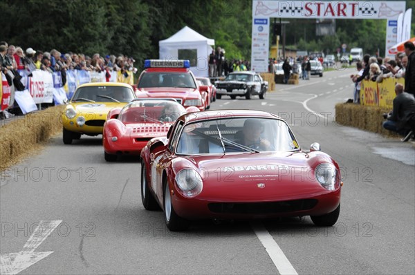 A red Abarth racing car drives on a road race track with spectators on the side, SOLITUDE REVIVAL 2011, Stuttgart, Baden-Wuerttemberg, Germany, Europe