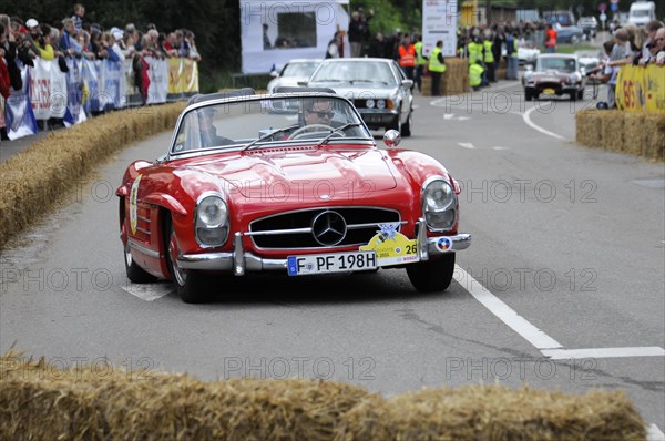 A red Mercedes 300SL Roadster on a race track, accompanied by spectators, SOLITUDE REVIVAL 2011, Stuttgart, Baden-Wuerttemberg, Germany, Europe
