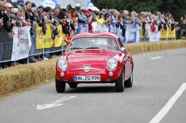 Red vintage sports car in a race with spectators, SOLITUDE REVIVAL 2011, Stuttgart, Baden-Wuerttemberg, Germany, Europe