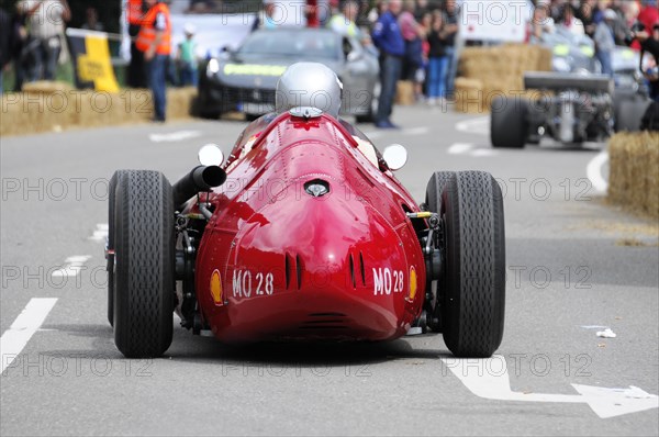 Rear view of a red historic racing car on the road with driver in helmet, SOLITUDE REVIVAL 2011, Stuttgart, Baden-Wuerttemberg, Germany, Europe