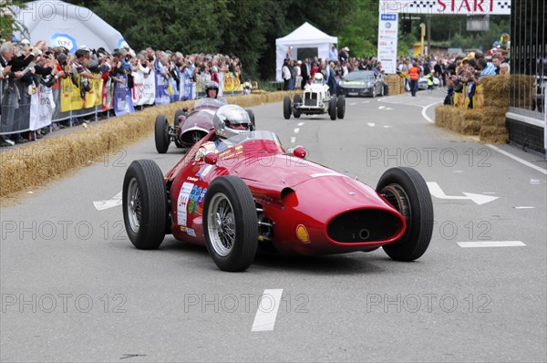 A red classic formula racing car drives past spectators on a cordoned-off road, SOLITUDE REVIVAL 2011, Stuttgart, Baden-Wuerttemberg, Germany, Europe