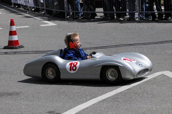 Child driving a soapbox during a competition, watched by spectators at the side of the track, SOLITUDE REVIVAL 2011, Stuttgart, Baden-Wuerttemberg, Germany, Europe