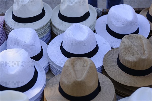The bay of Port Miou in Cassis, pile of white and natural-coloured hats on a market stall, Marseille, Departement Bouches-du-Rhone, Provence-Alpes-Cote d'Azur region, France, Europe