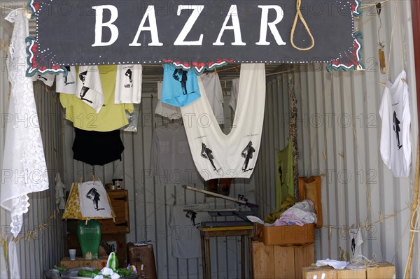 Art Bazaar Marseille, A sign of the bazaar with hanging clothes in the entrance area, Marseille, Departement Bouches-du-Rhone, Region Provence-Alpes-Cote d'Azur, France, Europe