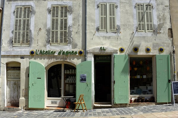 Marseille, Old building facade with green shutters and a small French-style shop, Marseille, Departement Bouches-du-Rhone, Provence-Alpes-Cote d'Azur region, France, Europe