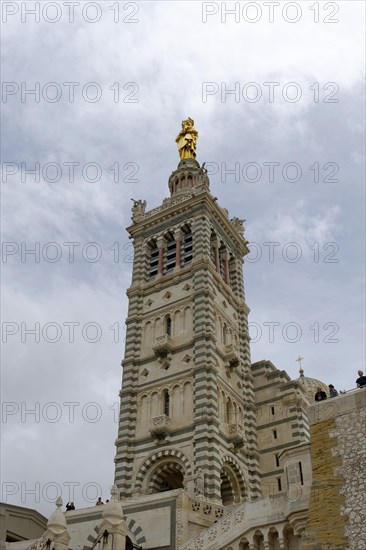 Madonna, Church of Notre-Dame de la Garde, Marseille, The steeple of a historic cathedral with a shining golden figure on top, Marseille, Departement Bouches-du-Rhone, Region Provence-Alpes-Cote d'Azur, France, Europe