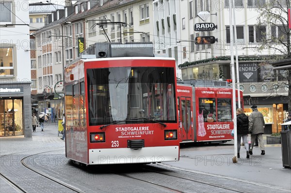 Wuerzburg, Red tram with advertising for Stadtgalerie runs in a pedestrian zone, Wuerzburg, Lower Franconia, Bavaria, Germany, Europe