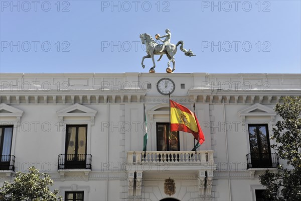 Granada, Horse statue on the roof of the town hall under a blue sky with flags, Granada, Andalusia, Spain, Europe