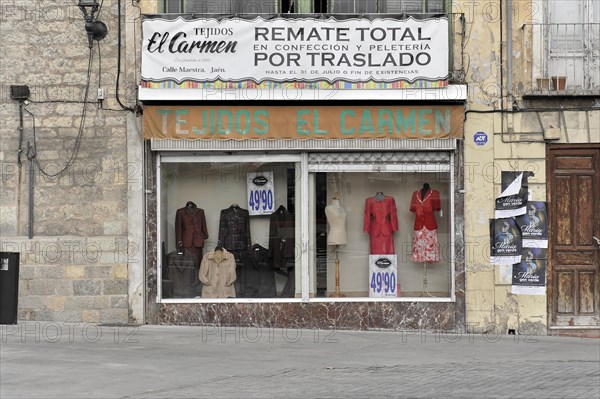 Jaen, Facade of a textile shop with shop window and advertisement for a sale, Jaen, Andalusia, Spain, Europe
