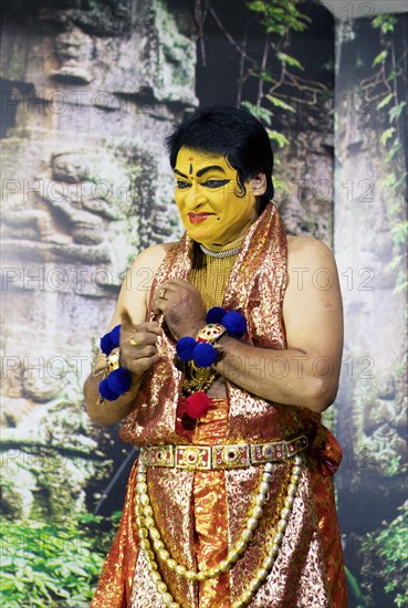 Kathakali performer or mime, 60 years old, on stage at the Kochi Kathakali Centre, Kochi, Kerala, India, Asia