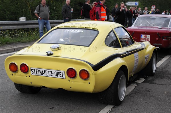 Rear end of a yellow vintage coupe with racing numbers and spectators, SOLITUDE REVIVAL 2011, Stuttgart, Baden-Wuerttemberg, Germany, Europe