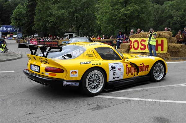 Rear view of a yellow racing car with sponsor logos on a race track at an event, SOLITUDE REVIVAL 2011, Stuttgart, Baden-Wuerttemberg, Germany, Europe