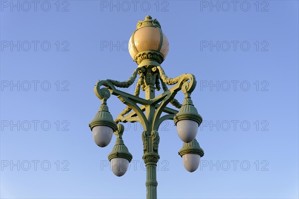 Decorated street lamp in front of a clear blue sky, Marseille, Departement Bouches-du-Rhone, Provence-Alpes-Cote d'Azur region, France, Europe