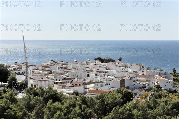 Solabrena, Sunny view of a Spanish coastal town with whitewashed houses and sea view, Andalusia, Spain, Europe