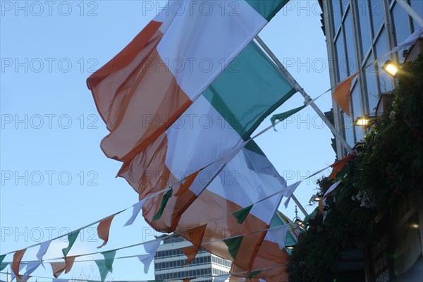 The Irish tricolour hanging in the breeze on a sunny day. Dublin, Ireland, Europe