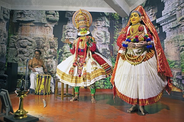 Kathakali performer or mime, 38 and 60 years old, and drummer on stage at the Kochi Kathakali Centre, Kochi, Kerala, India, Asia