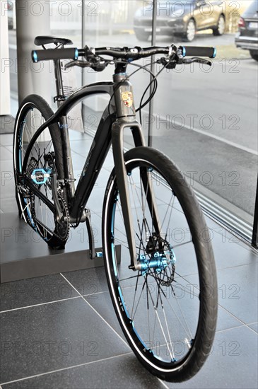 Modern e-bike (Porsche) with black frame and blue design elements in the showroom, Schwaebisch Gmuend, Baden-Wuerttemberg, Germany, Europe