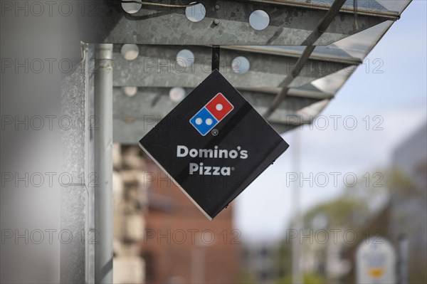Sign with logo of the American fast-food pizza chain Dominos Pizza in Berlin, 05/04/2024
