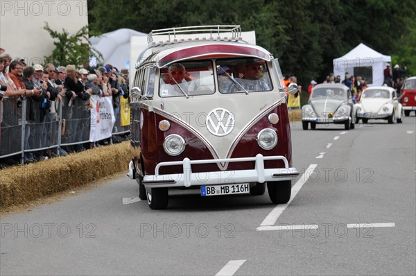 A two-coloured vintage Volkswagen bus drives on the road in front of spectators, SOLITUDE REVIVAL 2011, Stuttgart, Baden-Wuerttemberg, Germany, Europe