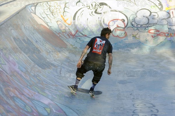 Teenager skateboarding on a ramp in a skate park decorated with graffiti, Marseille, Bouches-du-Rhone department, Provence-Alpes-Cote d'Azur region, France, Europe