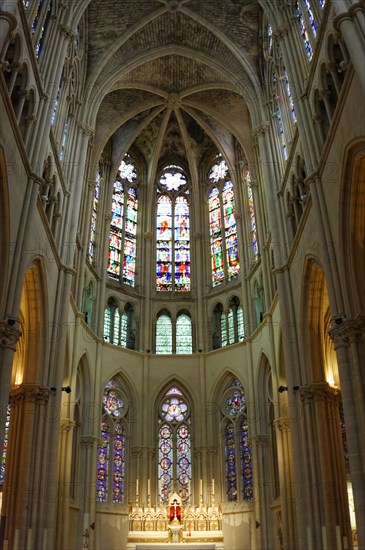 Church of Saint-Vincent-de-Paul, interior view of a church choir with Gothic stained glass windows and warm lighting conditions, Marseille, Departement Bouches-du-Rhone, Provence-Alpes-Cote d'Azur region, France, Europe