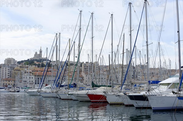 Marseille harbour, sailboats anchored in the marina against the backdrop of an old city, Marseille, Departement Bouches-du-Rhone, Region Provence-Alpes-Cote d'Azur, France, Europe