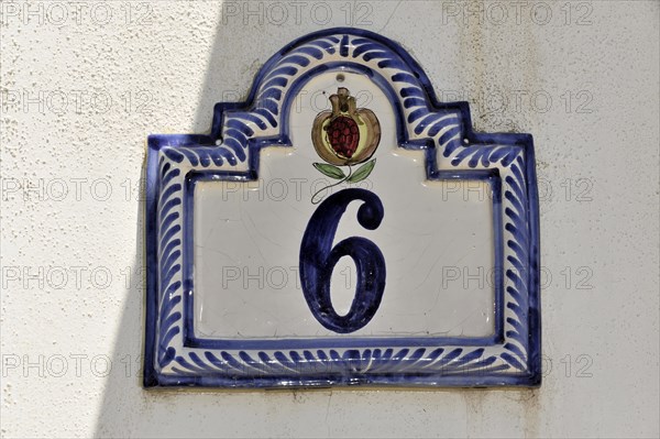 Solabrena, Blue and white ceramic house number with crown and ornaments on a wall, Andalusia, Spain, Europe