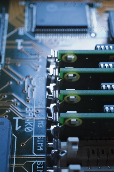 Close-up of blue and green lighted electronic computer circuit board with memory chip and lines, Studio Composition, Quebec, Canada, North America