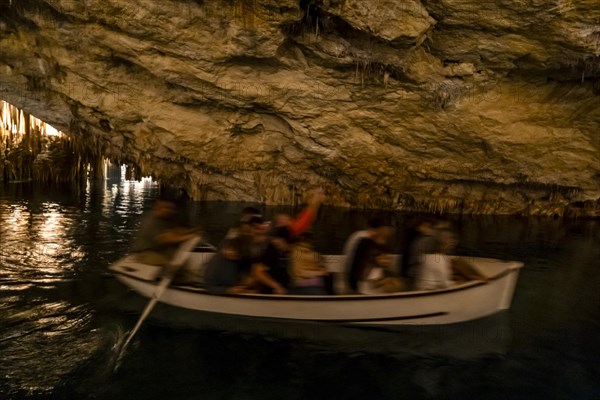 People in the boat on lake in amazing Drach Caves in Mallorca, Spain, Europe