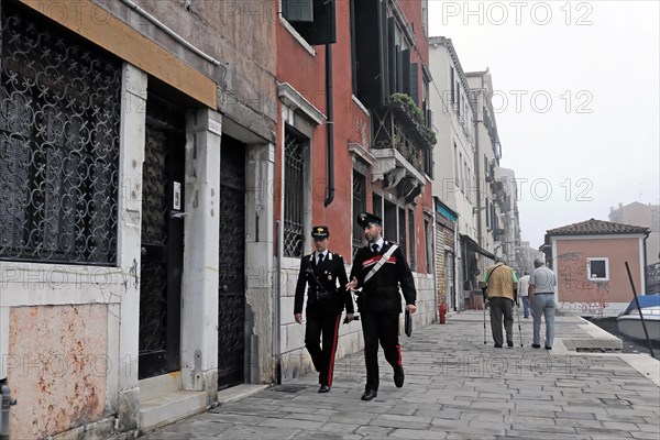 Island of Murano, Venice, Two policemen patrolling side by side on a street in Venice, Venice, Veneto, Italy, Europe