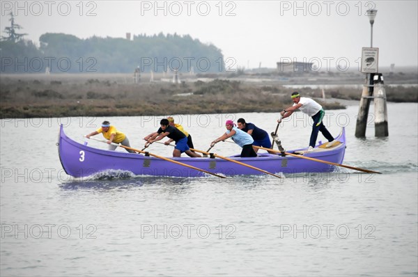 Burano, Burano Island, A group of rowers in a competition on calm water, Burano, Venice, Veneto, Italy, Europe