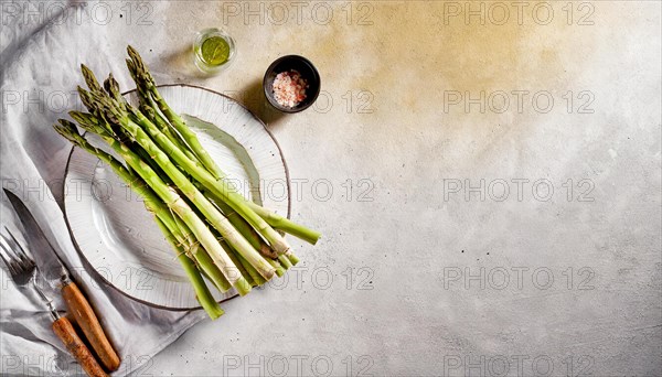 Fresh asparagus on a white plate with cutlery and spices, in natural light, AI generated, AI generated